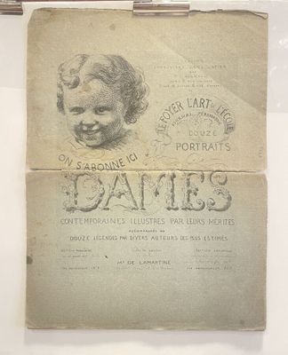 an old book with a drawing of a child ' s face on it