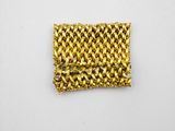 a close up of a piece of gold woven fabric on a white surface