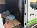 a white van with the door open with a lot of items in it