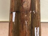 a close up of a piece of wood with peeling paint on it