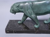 statue of a green panther on a marble base on a white background