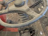 a steering wheel of a tractor that is parked in a garage