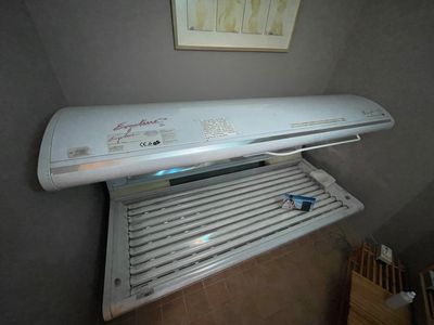 a white air conditioner sitting on top of a shelf