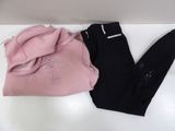 two pairs of leggings and a hoodie on a white table