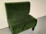 a green chair that is sitting in the corner of a room