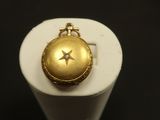 a gold locke with a star on it on a stand