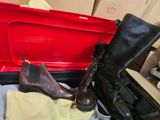 a pair of brown boots sitting in a red suitcase