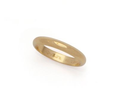 a close up of a gold ring on a white background