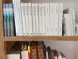 a book shelf with many books on top of it