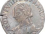 a silver coin with an image of a woman wearing a headdress