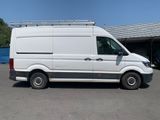 the white van is parked in a parking lot near a building
