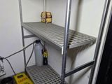 a metal shelf in the corner of a room