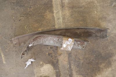 a piece of metal on the ground next to a pair of scissors