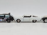 several toy cars are lined up in a row on a white surface