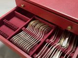 a red box with a bunch of silverware inside of it