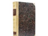 an old book sitting on top of a white surface