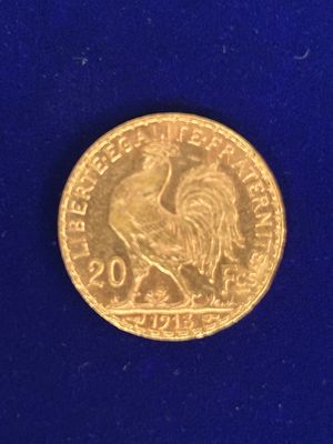 l'image d'une pièce d'or ornée d'un coq