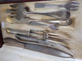 a lot of silverware in a case on a table