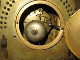 a close up of a gold clock with holes in it