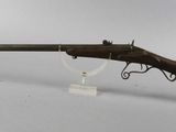 an old rifle with a wooden barrel and a metal handle