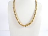 a close up of a gold necklace on a mannequin mannequin