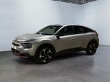 a silver suv parked in a large room with a white wall