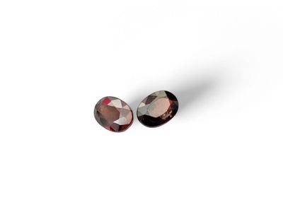 a pair of pink tourmaline gems on a white background