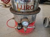 a large metal bucket with a gauge on top of it