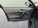 the door of a car with the driver ' s seat open