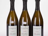 three bottles of wine sitting next to each other on a white surface