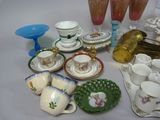 many different types of tea cups and saucers on the table