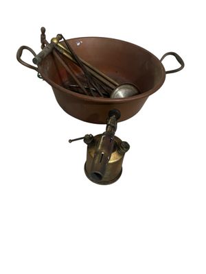 a brown bowl with spoons in it on a white background