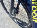 a close up of a bike with a school sticker on the front wheel