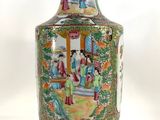 a vase with a painting on it sitting on a table
