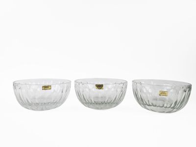 three clear glass bowls sitting on top of a white surface