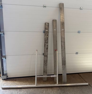 several pieces of metal are stacked up against a garage door