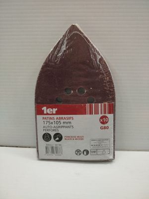 une photo d'un disque abrasif rouge posé sur une surface blanche