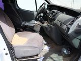 the interior of a car with the door open and the seat down