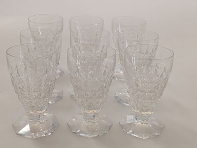 six wine glasses sitting on a table with a white background
