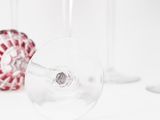 three wine glasses sitting next to each other on a table