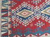 an oriental rug with a red, blue, and green design on it