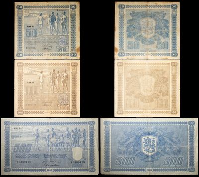 four different types of old paper money on a black background