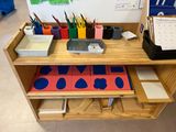 a wooden desk with a lot of supplies on top of it