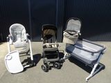 three strollers and a baby carriage in a parking lot
