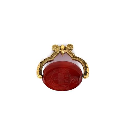 a close up of a red and gold broocher on a white background