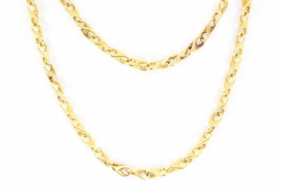 a close up of a gold chain on a white background