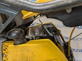 a close up of a yellow motorcycle with a black seat