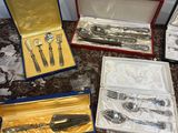 a lot of silverware in a box on a table