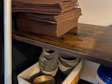 a stack of books on a shelf in a kitchen
