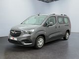 the grey van is parked in a large room with a black floor